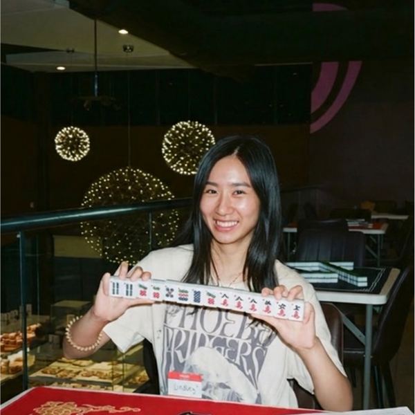 A guest showing her tiles at Friends & Family night